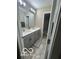 Bathroom featuring a double vanity with gray cabinets and brushed nickel hardware at 9851 Pica Dr, Fishers, IN 46040