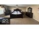 Spacious bedroom featuring plush carpeting, large windows, and dark wood furnishings at 9851 Pica Dr, Fishers, IN 46040