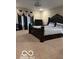 Elegant bedroom featuring a king-size bed, chandelier, and neutral carpet at 9851 Pica Dr, Fishers, IN 46040