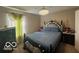 Bedroom with an ornate dark wood bed frame, plush bedding, and decorative window treatments at 9851 Pica Dr, Fishers, IN 46040