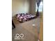 Modest bedroom with a bed on the floor, a window, and neutral carpet at 9851 Pica Dr, Fishers, IN 46040