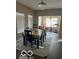 Bright dining room features a large dining table, chandelier and an open floor plan at 9851 Pica Dr, Fishers, IN 46040