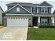 Charming two-story home with a well-manicured lawn and attached two car garage at 9851 Pica Dr, Fishers, IN 46040