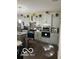Bright kitchen with stainless steel appliances, gray cabinets, and stylish decor at 9851 Pica Dr, Fishers, IN 46040