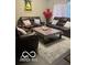 Cozy living room with reclining sofas, patterned rug, and a coffee table with decorative items at 9851 Pica Dr, Fishers, IN 46040