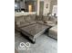 Living room with a comfortable sectional sofa, patterned rug, and a stylish coffee table at 9851 Pica Dr, Fishers, IN 46040