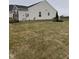 Spacious backyard featuring sod, mature trees, and a freshly mulched garden at 99 Gnarled Oak Ln, Whiteland, IN 46184