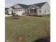 Charming single-story home with a combination of stone and siding and a well-manicured lawn at 99 Gnarled Oak Ln, Whiteland, IN 46184