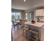 Bright eat-in kitchen featuring white cabinets, island with breakfast bar, and stainless steel appliances at 99 Gnarled Oak Ln, Whiteland, IN 46184