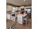 Bright eat-in kitchen featuring white cabinets, island with breakfast bar, and stainless steel appliances at 99 Gnarled Oak Ln, Whiteland, IN 46184