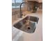 Close-up of stainless steel kitchen sink, pull-down faucet and quartz countertops at 99 Gnarled Oak Ln, Whiteland, IN 46184