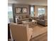Inviting living room with neutral tones, comfortable seating, and large windows offering natural light at 99 Gnarled Oak Ln, Whiteland, IN 46184