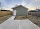 Backyard featuring a concrete patio and pathway leading to a detached garage or shed at 1038 St Peter St, Indianapolis, IN 46203