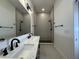 This bathroom features a double vanity with white sinks and a tiled walk-in shower at 1038 St Peter St, Indianapolis, IN 46203