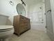 Cozy bathroom with a wooden vanity, round mirror, and a shower-tub combo at 1038 St Peter St, Indianapolis, IN 46203