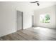 Bright bedroom features wood-look flooring, a modern ceiling fan and a sun-filled window at 1038 St Peter St, Indianapolis, IN 46203