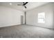 Bright bedroom with gray carpet, a modern ceiling fan, and a large window at 1038 St Peter St, Indianapolis, IN 46203