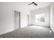 Spacious bedroom features gray carpet, a modern ceiling fan, and a sun-filled window at 1038 St Peter St, Indianapolis, IN 46203