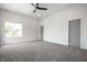 Spacious bedroom with gray carpet, a modern ceiling fan, and a sun-filled window at 1038 St Peter St, Indianapolis, IN 46203
