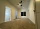 Spacious bedroom with a ceiling fan, large window, and neutral carpeting at 1038 St Peter St, Indianapolis, IN 46203