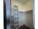 Bright walk-in closet with built-in shelving and a hanging rod at 1038 St Peter St, Indianapolis, IN 46203