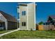 Modern three-story home with vibrant green siding complemented by bright white trim and a well-manicured lawn at 1038 St Peter St, Indianapolis, IN 46203