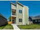 Striking contemporary home boasts a unique three-story design with a private balcony and modern curb appeal at 1038 St Peter St, Indianapolis, IN 46203