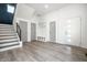 Bright foyer with wood-look flooring, stylish storage, and a modern front door at 1038 St Peter St, Indianapolis, IN 46203