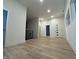 Bright hallway leading to the rooms with neutral paint and floors at 1038 St Peter St, Indianapolis, IN 46203