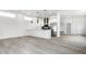 Open-concept kitchen featuring white cabinets, stainless steel appliances, and hardwood floors at 1038 St Peter St, Indianapolis, IN 46203