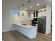 Bright kitchen with white cabinets, stainless appliances, and a marble countertop island at 1038 St Peter St, Indianapolis, IN 46203