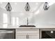 Contemporary kitchen with white cabinets, stainless steel sink, and modern appliances at 1038 St Peter St, Indianapolis, IN 46203
