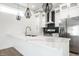 Bright kitchen with white cabinets, a marbled countertop, and modern pendant lighting at 1038 St Peter St, Indianapolis, IN 46203