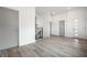 Open-concept living space with wood-look floors, staircase, and stylish front door at 1038 St Peter St, Indianapolis, IN 46203