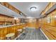 Finished basement with bar area, wood paneling, and vinyl flooring at 1061 N Layman Ave, Indianapolis, IN 46219