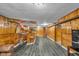 Finished basement with wood paneling, vinyl flooring and a bar with seating at 1061 N Layman Ave, Indianapolis, IN 46219