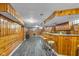 Finished basement featuring a bar area, wood paneling, and laminate flooring at 1061 N Layman Ave, Indianapolis, IN 46219