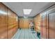 Finished basement featuring paneled walls, drop ceiling, and equipment at 1061 N Layman Ave, Indianapolis, IN 46219