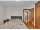 Bedroom featuring hardwood floors and a gray bed with a gray upholstered headboard at 1061 N Layman Ave, Indianapolis, IN 46219