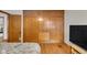 Bedroom with built-in closets, hardwood floors, and a bed with gray comforter at 1061 N Layman Ave, Indianapolis, IN 46219