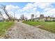 Long driveway leads to a charming home with mature landscaping and a detached garage at 1061 N Layman Ave, Indianapolis, IN 46219