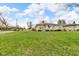 Lovely single-story home with stone exterior and a well-maintained front lawn under a blue sky at 1061 N Layman Ave, Indianapolis, IN 46219