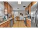 Eat-in kitchen with stainless steel appliances, wood cabinets, and backsplash at 1061 N Layman Ave, Indianapolis, IN 46219