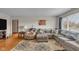 Cozy living room with hardwood floors, a comfortable sectional sofa, and ample natural light at 1061 N Layman Ave, Indianapolis, IN 46219