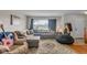 Spacious living room featuring a large window, sectional sofa, and stylish decor at 1061 N Layman Ave, Indianapolis, IN 46219