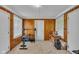 Workout area featuring paneled walls, tile floors, and exercise equipment at 1061 N Layman Ave, Indianapolis, IN 46219