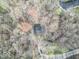 Overhead view of a home hidden amongst trees, emphasizing privacy and a natural setting at 10614 W Hickory Ct, Quincy, IN 47456
