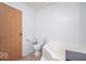 Bathroom featuring a bathtub, toilet, and wood cabinet at 10614 W Hickory Ct, Quincy, IN 47456
