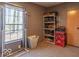 Functional closet space with storage shelving, clothing rack, and a window for ventilation and light at 10614 W Hickory Ct, Quincy, IN 47456