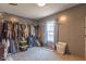 Spacious walk-in closet with ample clothing racks, storage bins, and a window providing natural light at 10614 W Hickory Ct, Quincy, IN 47456